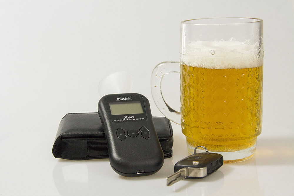 Breathalyzer, wallet, key and beer