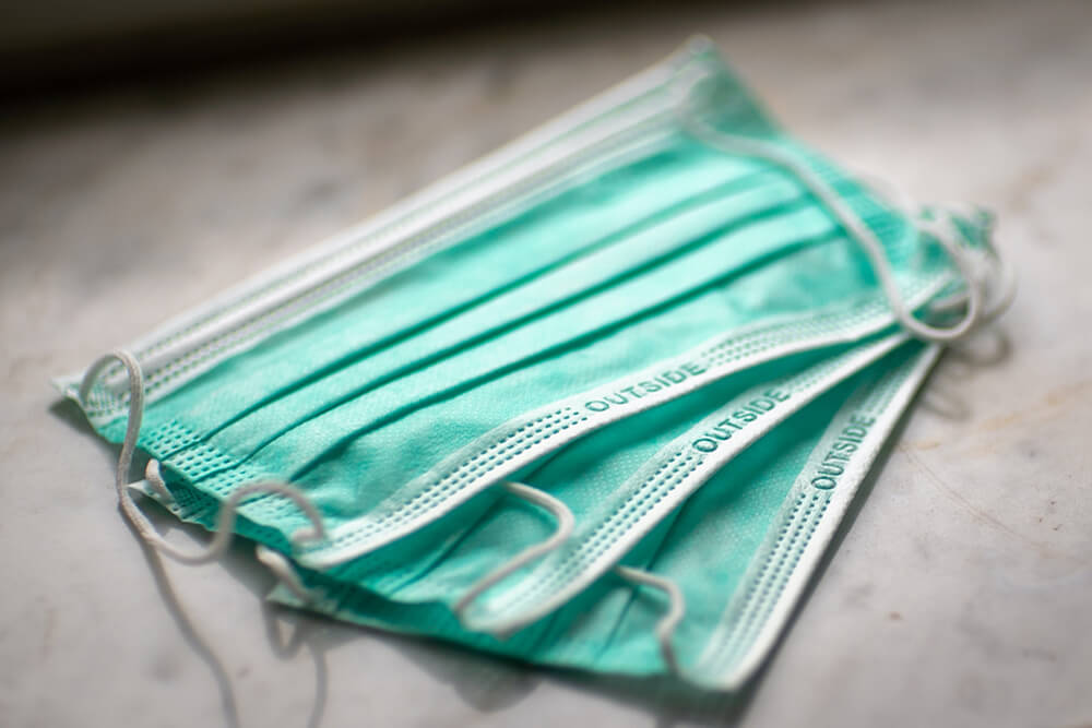 Three medical face masks on table